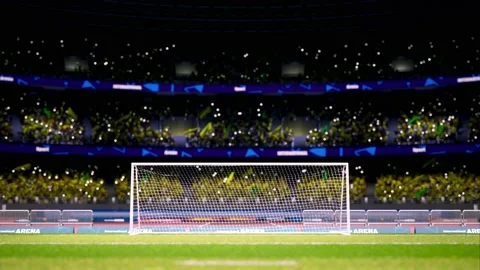 Crowd fan with flags around night soccer arena waving flashlights Stock Footage 155759261