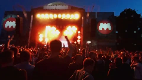 Crowd of fans are cheering at open-air music festival, back view. Live concert. Stock-Footage 154158250