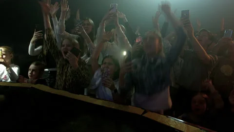 A crowd of fans of different ages dances and shouts near the stage. Stock Footage 194546979