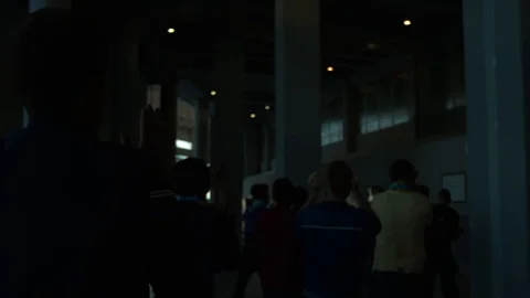A crowd of fans goes down the hall after football, claps and screams Stock Footage 118730018