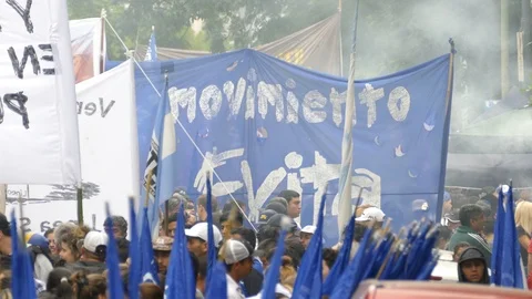 Crowd with flags and smoke rising from unknown source in South America Video stock 100195012