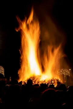 Crowd in front of a dancing flame Stock Photos