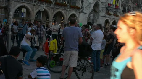 Crowd gathered around acordeon player in Marienplatz Munich Stock Footage 50973250