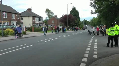 Crowd gathers police wait on corner Stock Footage 14689507