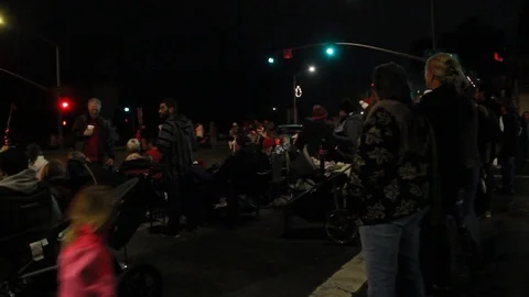 A crowd gathers in the street for a parade Stock Footage 83598543