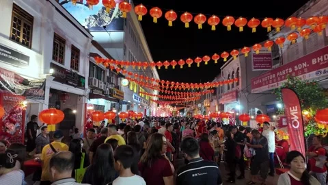 Crowd gathers under glowing red lanterns at Lebuh Presgrave Video stock 327805255