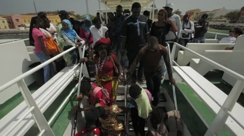 Crowd getting of a ferry in Goree, Senegal Stock Footage 47936867