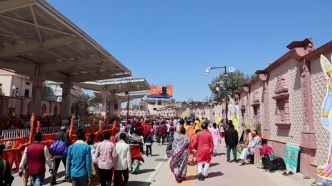 Crowd of Hindu Devotees walking towards Ram Temple Complex on Sunny Day in Stock Footage 338402648