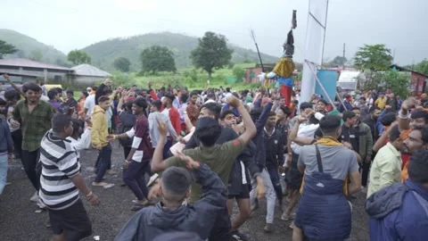 The crowd of Hindu pilgrims and devotees dancing and celebrating the holy Stock Footage 255348491
