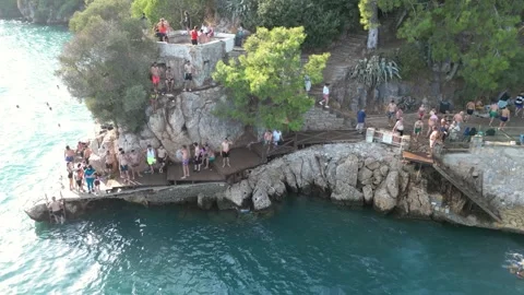 Crowd Jumping and Diving into Sea - Akyaka Turkey 16 Aug 2023 Stock Footage 329378671