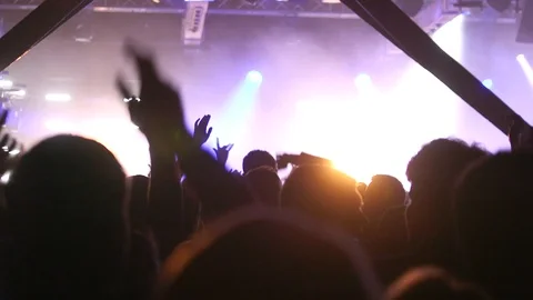 Crowd jumping and hands in air at concert Stock Footage 119279042
