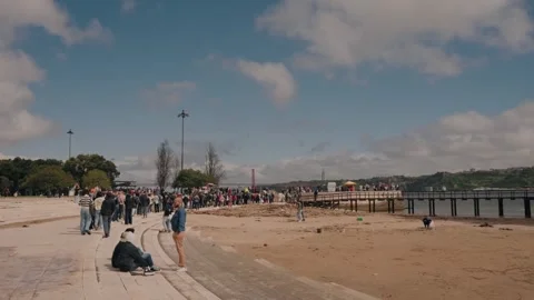 Crowd lines up along riverbank to visit lisbon’s historic belém tower Stock Footage 310539847