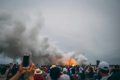 Crowd looking at smoking fire Stock Photos
