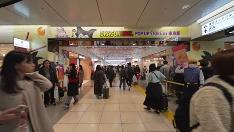 Crowd making their way along promotional banners of anime Dragon Ball Daima Stock Footage 297776596