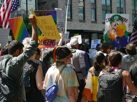 Crowd marching with signs and flags for freedom and human rights Stock Photos