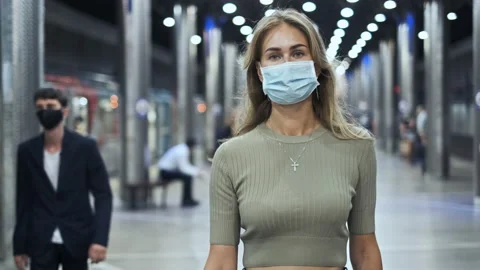 Crowd masked face walking in station metro coronavirus. Woman in subway covid-19 Stock Footage 142403932