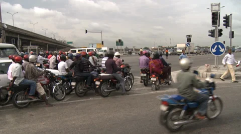 Crowd of motorbikes pull away from junction Stock Footage 38387372