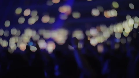 Crowd of music fans with lights in dark concert hall Stock Footage