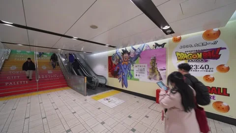 Crowd navigating through staircase with a poster of anime Dragon Ball Daima. Stock Footage 297777345