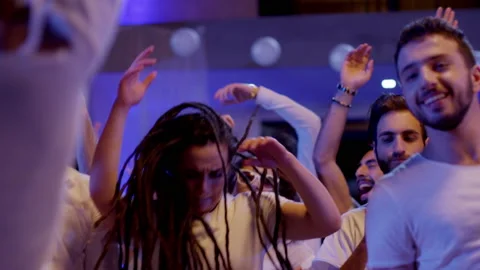 Crowd or group of white dressed young, stylish multi-ethnic people during party Stock Footage 132345561