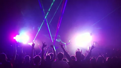 Crowd partying, dancing at a concert. The crowd raises his hands up and dancing Stock Footage 64702816
