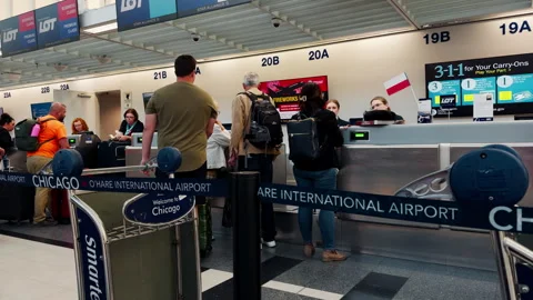 Crowd of Passengers checking baggage at airline check inside Chicago O'Hare Stock Footage 338319241