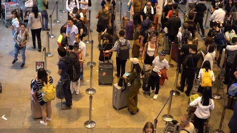 Crowd passengers with luggage in queue at check-in counter at airport, Thailand Stock-Footage 109159853