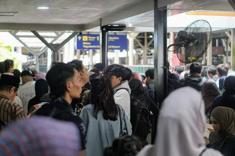A crowd of passengers packed the electric train station area during rush hour Stock Photos