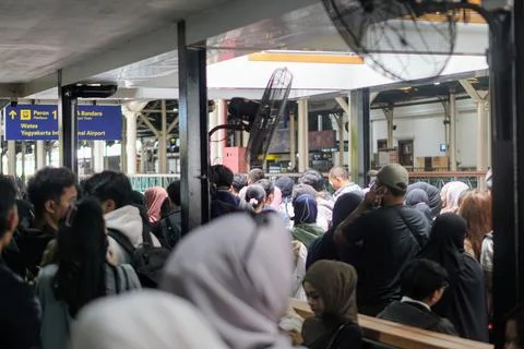 A crowd of passengers packed the electric train station area during rush hour Stock Photos