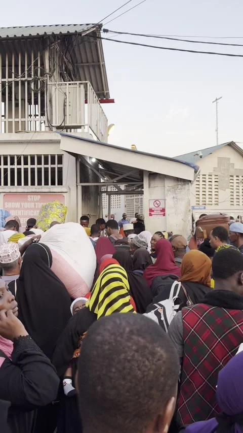 Crowd of passengers waiting to enter ferry terminal at Malindi Port Zanzibar Stock Footage 344476731