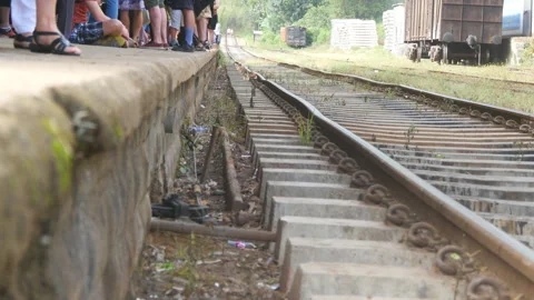 Crowd of passengers waiting for a train arrival on the station at sunny day Stock Footage 315094309