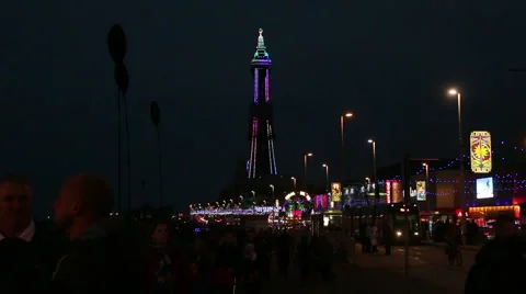 Crowd passing blackpool tower dark blue sky Stock Footage 48483552