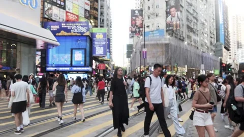 Crowd passing the traffic road in Causeway Bay Hong Kong Stock Footage 313486501