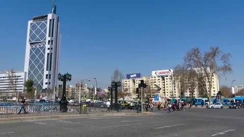 Crowd of pedestrians crossing avenue while two big, blue buses pass by Stock Footage 97083898