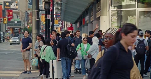 A crowd of pedestrians crossing an intersection in Toronto during rush hour. Video stock 278014865