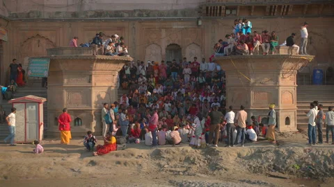Crowd of people and devotees sitting on historic stone ghat steps Stock Footage 341109370