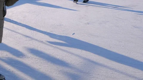 Crowd of People are Skating on Ice Rink in the Sunny Day. Slow Motion Stock Footage 101019534
