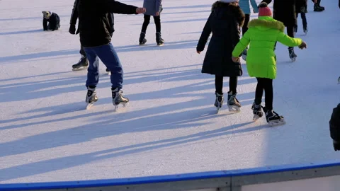 Crowd of People are Skating on Ice Rink in the Sunny Day. Slow Motion Stock Footage 101404373