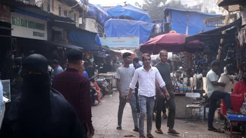 Crowd of people, bikes, dingy shops in a congested slums in Mumbai, India Stock Footage 329098590