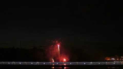 A crowd of people on the bridge watching a firework and celebrating a holiday. Stock Footage 77153226