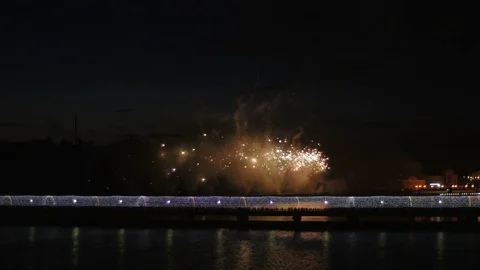 A crowd of people on the bridge watching a firework and celebrating a holiday. Stock Footage 77153602