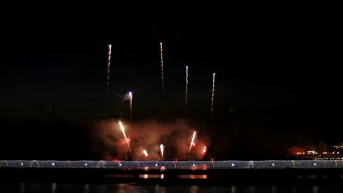 A crowd of people on the bridge watching a firework and celebrating a holiday. Stock-Footage 77177918