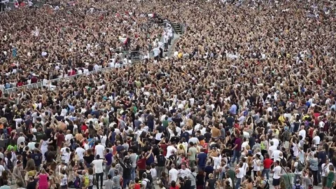 Crowd of people dancing at the event and raising arms Stock Footage 77680530