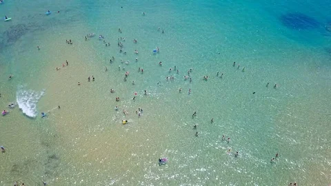 Crowd of people enjoying the cool mediterranean sea - Aerial footage Stock Footage