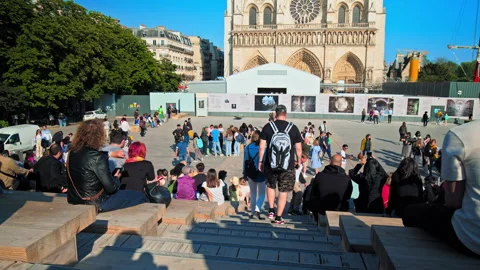 A crowd of people enjoys the Square view of the Medieval Cathedral. Stock Footage 245453502