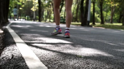 A crowd of people exercising and riding bikes through a lush park Video stock 283705723