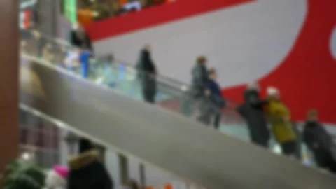 A crowd of people on fast-moving escalators in a modern shopping mall. Blurred 스톡 동영상 329217150