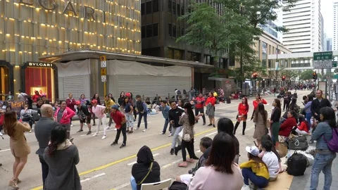 A crowd of people getting ready to do a flashmob together on a busy street Stock Footage 146590967