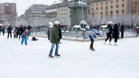 Crowd of people ice skating in a circular rink in city center before new year Stock Footage 70647226