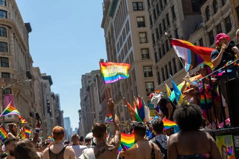 Crowd of people with LGBT flags marching at a pride parade 库存照片